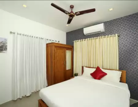 Comfortable well-furnished patient room at Focuz AyurCentre with flat screen TV and WiFi